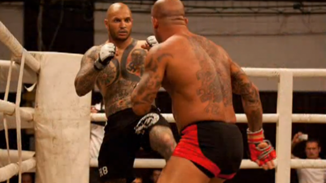 Atilla Petrovszki (left) sporting his anti-Semitic tattoos in a mixed martial arts fight. (photo credit: image capture from YouTube)