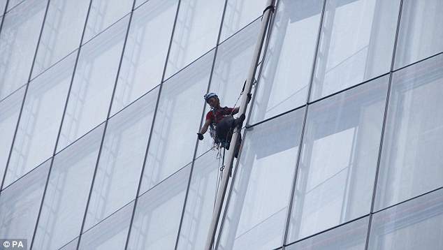 Head for heights: Liesbeth Debbens from the Netherlands gives the thumbs-up as he makes her way up the skyscraper for Greenpeace's Save the Arctic campaign 