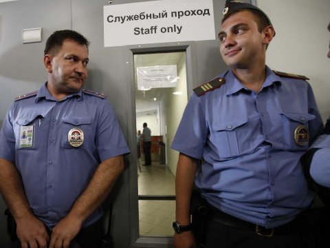 Police guard a door where human rights groups were taken to meet former intelligence agency contractor Edward Snowden at Sheremetyevo airport July 12, 2013.