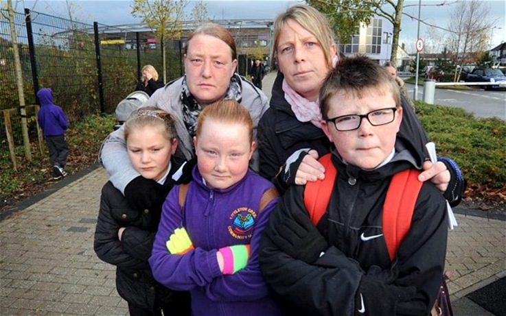 Parents Donna Ward left and Tracy Ward right with their children left to right Caitlyn Lakin aged 8 Chloe Ward aged 8 and Harry Lakin aged 9 outside the school