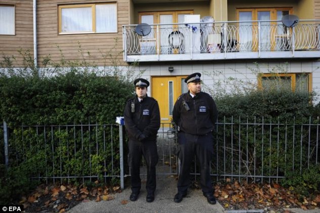 Police stand gurad in front of the property in Brixton, London