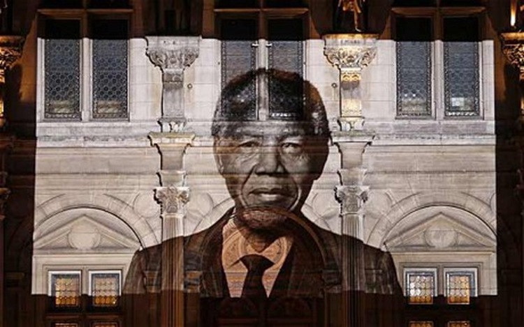 A giant Nelson Mandela projected on the facade of a town hall in Paris.