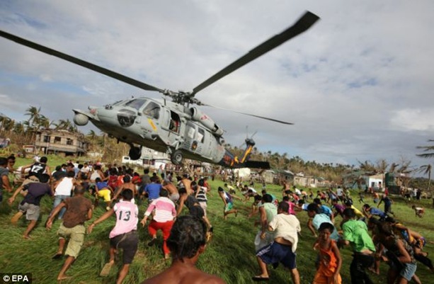Filipinos rush to get relief goods from a helicopter drop. Scenes like this bear no resemblance to what actually happens with the majority of the supplies.
