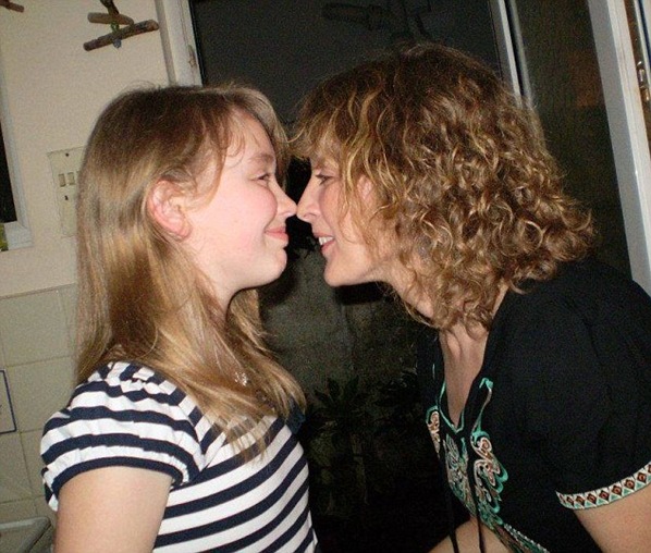 Izzy with her mother. They had been living in Australia which is still predominantly White, so the feral behaviour of modern British youth must have been quite a shock to her.