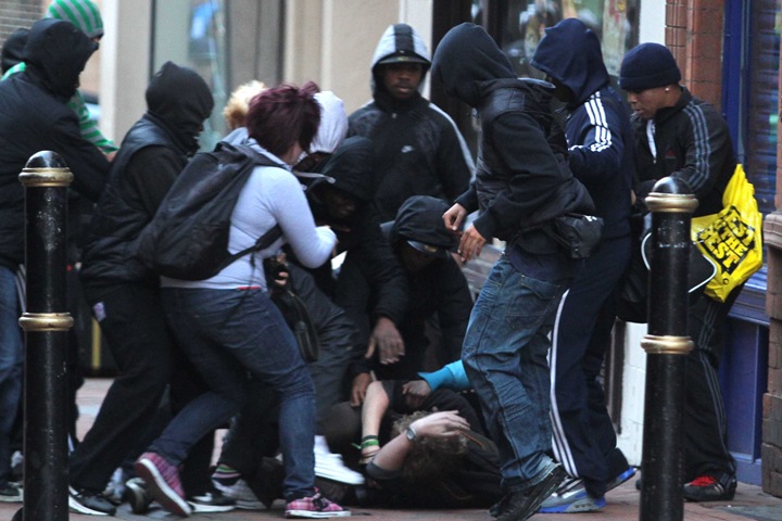 BIRMINGHAM, UNITED KINGDOM - AUGUST 8: Photographer Harry Smith is beaten and mugged. Riots have begun in Birmingham city centre, August 8, 2011. Shop fronts have been smashed and there are reports of looting. One photographer, Harry Smith, was beaten up and had his wallet and camera stolen. It follows rioting in London over the weekend.   (Photo by Mathew Growcoot/newsteam)