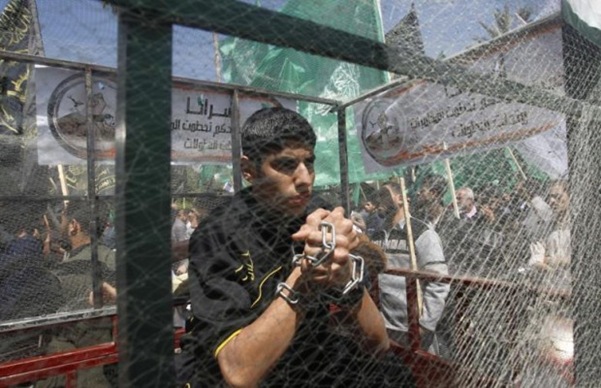 A Palestinian child kept outdoors in a cage by the Jews.