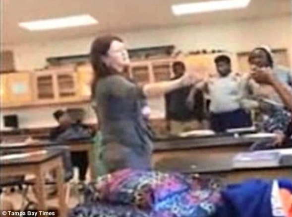 A teacher at a Florida high school is caught on camera as she unsuccessfully tries to stop two girls from fighting in her classroom. At one point she became a barricade between the girls
