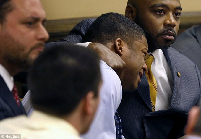 Defense attorney Walter Madison (right) comforts Ma'Lik Richmond (left) as Richmond reacts to the verdict during his trial at the juvenile court in Steubenville, Ohio on March 17, 2013