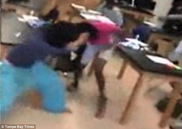 She drags the girl to the ground by her hair as a classmate films the vicious fight