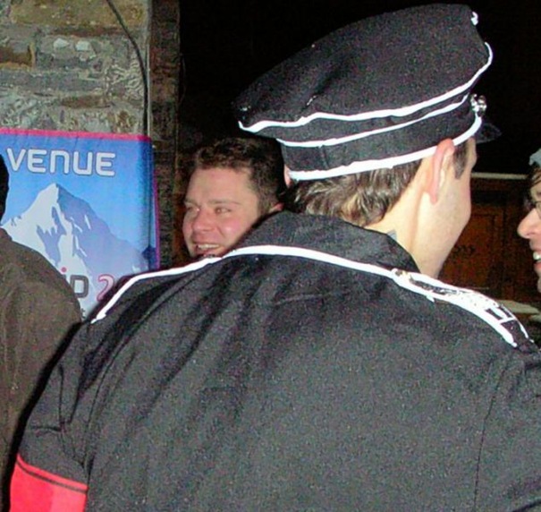 Aidan Burley is seen over the shoulder of Mark Fournier in a Nazi style SS uniform at a venue in Val Thorens in the French Alps in 2011