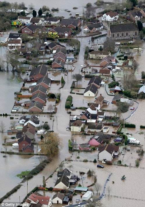 Water surrounds flooded properties in the village of Moorland on the Somerset Levels near Bridgwater