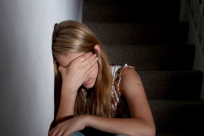 Young-girl-sitting-on-dark-stairs-1794430