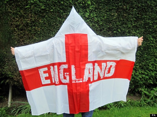 A man wears a "wearable England flag" made by Asda, as the supermarket defended the flag after claims it resembles a Ku Klux Klan outfit. PRESS ASSOCIATION Photo. Picture date: Friday May 30, 2014. The £3 St George's Cross, with the word "England" on the red cross, features a hood which Asda said was to allow fans to wear it and stay dry despite the unpredictable British weather. See PA story CONSUMER Flag. Photo credit should read: Carmel Wilkinson/PA Wire