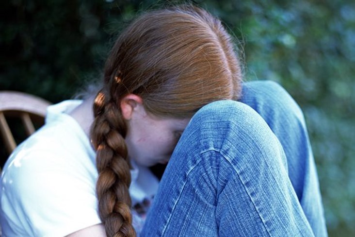 Sad-girl-sitting-outdoors