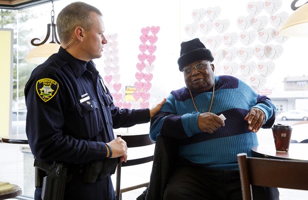 Springfield Police Officer Bryan Henson talks with William Logan during a Coffee with a Cop event Wednesday, Feb. 11, 2015 at McDonald's on South Grand Avenue East. Rich Saal/The State Journal-Register