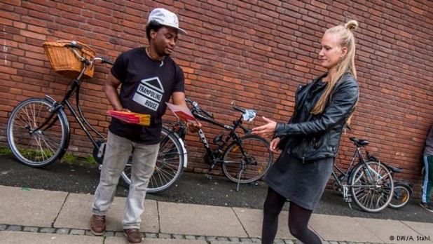 An immigrant hands a Dane a flier asking for her support in taking over her country. I wonder if he even bothers handing them to men?