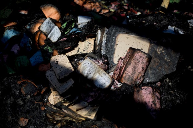 Partially burnt prayer books and leaflets lay in the heavily damaged Church of Multiplication near the Sea of Galilee in Tabgha, Israel, Thursday, June 18, 2015. Israel police spokesman Micky Rosenfeld said police are investigating whether the fire was deliberate and are searching for suspects. A passage from a Jewish prayer, calling for the wiping out of idol worship, was found scrawled in red spray paint on a wall outside the church. (AP Photo/Ariel Schalit)