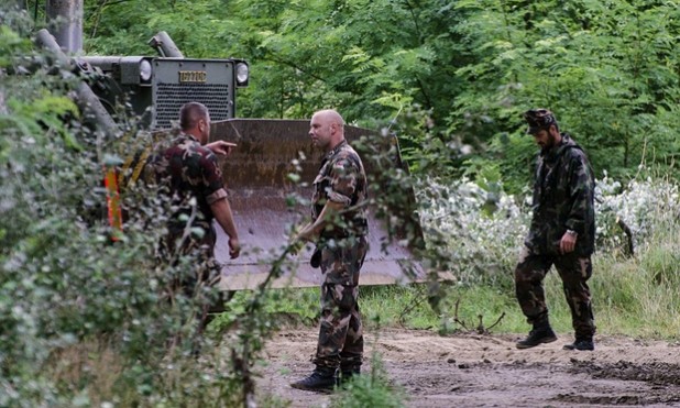 Soldiers defend the bulldozer.