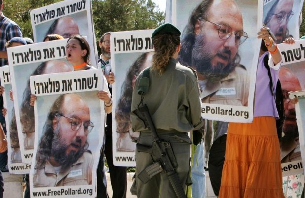 Israeli protesters hold posters of Jonathan Pollard in front of Israeli Prime Minister's office in Jerusalem.  Israeli protesters hold posters of Jonathan Pollard, who was convicted for spying on the United States in 1987, in front of the Israeli Prime Minister's office in Jerusalem June 19, 2005. The protest, calling for Pollard's release from a US prison, took place during U.S. Secretary of State Condoleezza Rice's meeting with Israeli Prime Minister Ariel Sharon. REUTERS/Ammar Awad - RTREUY7