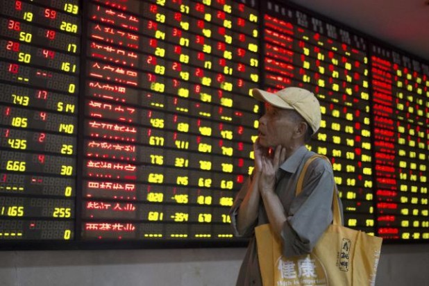 Chinese man watches his stocks in dog meat collapse.