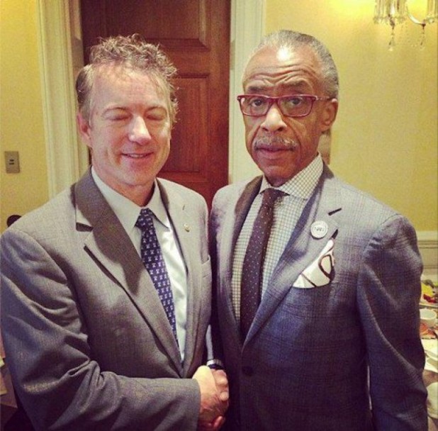 Rand's wife took this photo of him reaching down to begin prepping Al Sharpton.