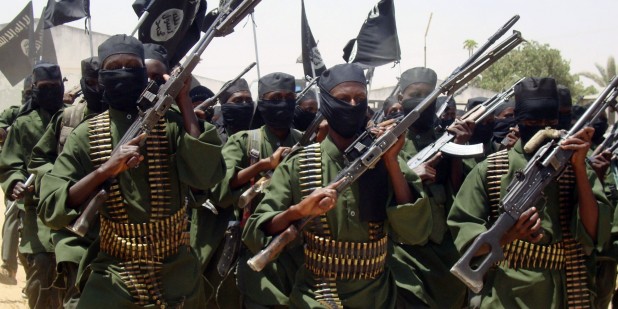 In this photo taken Thursday Feb.17, 2011 Al-Shabab fighters march with their guns during military exercises on the outskirts of Mogadishu,Somalia. The Somali government promised fighters valuable rewards if they deserted from the Islamist rebels group battling for control of the country. Good salaries. Education. Health care.(AP Photo/Mohamed Sheikh Nor)