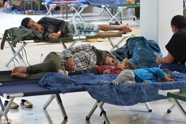2C6C614F00000578-3249667-Refugees_rest_in_a_former_furniture_factory_after_crossing_the_b-a-109_1443223064354