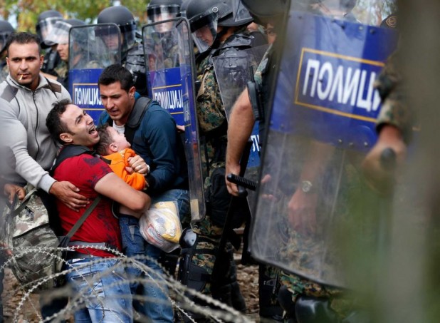 Pushing the right buttons with the West's pathological altruists: Border-breaching migrant shoving his child against Macedonian police cordon