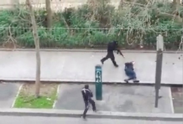 A police officer pleads for mercy on the pavement before being shot in the head by masked gunmen during an attack on the headquarters of the French satirical newspaper Charlie Hebdo in Paris, France, on January 7, 2015. Gunmen have attacked the Paris office of French satirical magazine Charlie Hebdo, killing 12 people and injuring seven, French officials say. At least two masked attackers opened fire with assault rifles in the office and exchanged shots with police in the street outside before escaping by car. President Francois Hollande said there was no doubt it had been a terrorist attack "of exceptional barbarity". A major police operation is under way in the Paris area to catch the killers. Screen capture via ABACAPRESS.COM