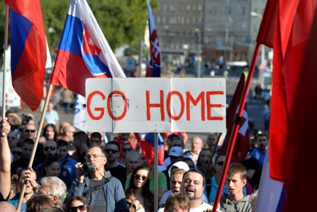 Participants hold flags and a banner during an anti-immigration rally organised by an initiative called “Stop Islamisation of Europe” and backed by the “People’s Party-Our Slovakia” on September 12, 2015 in Bratislava, Slovakia. AFP PHOTO / Samuel Kubani