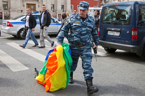 Moscow, Russia, 27/05/2012. A policeman carries a seized gay rights banner at an attempted gay pride parade in central Moscow. Several dozen people were arrested during clashes as Russian nationalists attacked gay rights activists during their seventh attempt to hold a gay pride parade in the Russian capital.