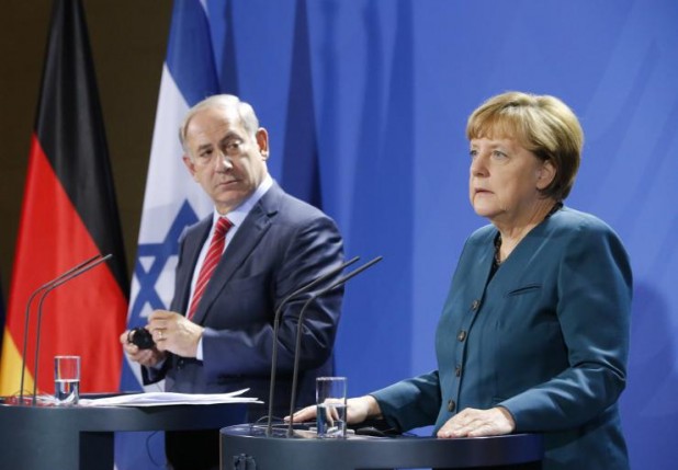 Berlin: Netanyahu absolves Germans for hoax, Merkel insists they must continue to be punished for generation after generation.