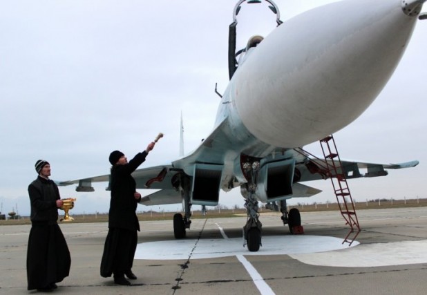 A Russian orthodox priest blesses a SU-27 SM fighter jet at the Belbek military airport outside Sevastopol. Sort of sends a bit of a shiver down your spine, no?