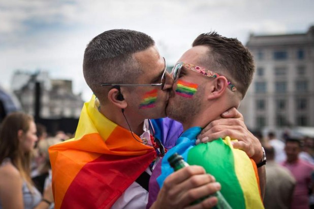 LONDON, ENGLAND - JUNE 27: A couple kiss in Trafalgar Square after the annual Pride in London Parade on June 27, 2015 in London, England. Pride in London is one of the world's biggest LGBT+ celebrations as thousands of people take part in a parade and attend performances at various locations across the city. (Photo by Rob Stothard/Getty Images)