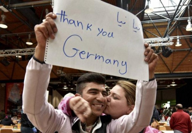 Here is a German woman literally kissing an Afghan man as he arrives in Germany.