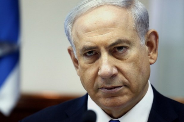 Israeli Prime Minister Benjamin Netanyahu looks on as he chairs the weekly cabinet meeting on July 6, 2014 at his Jerusalem office. Violence which rocked east Jerusalem for three days following the kidnap and murder on July 2 of a Palestinian teenager, spread to half a dozen Arab towns in Israel.   AFP PHOTO / POOL /GALI TIBBON