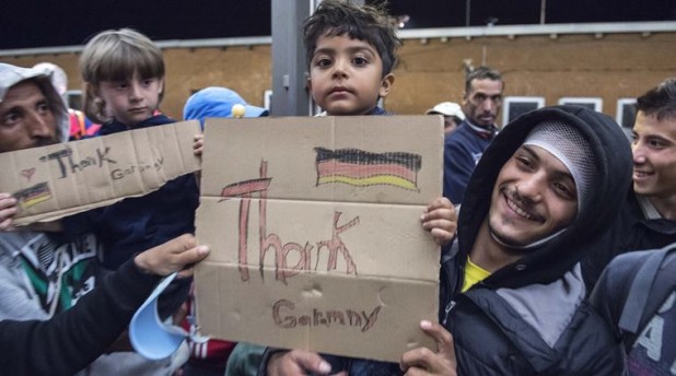 Refugees arrive at the train station in Saalfeld, central Germany, Saturday, Sept. 5, 2015. Hundreds of refugees arrived in a train from Munich to be transported by busses to an accomodation centre. (AP Photo/Jens Meyer)