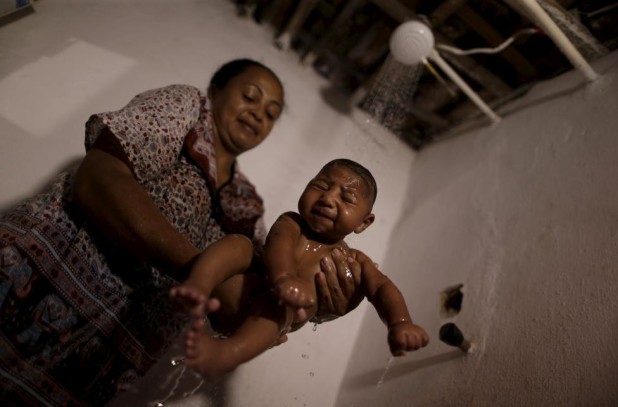 Hilda Venancio bathes her son Matheus, who has microcephaly, in Recife, Brazil, January 27, 2016. REUTERS/Ueslei Marcelino