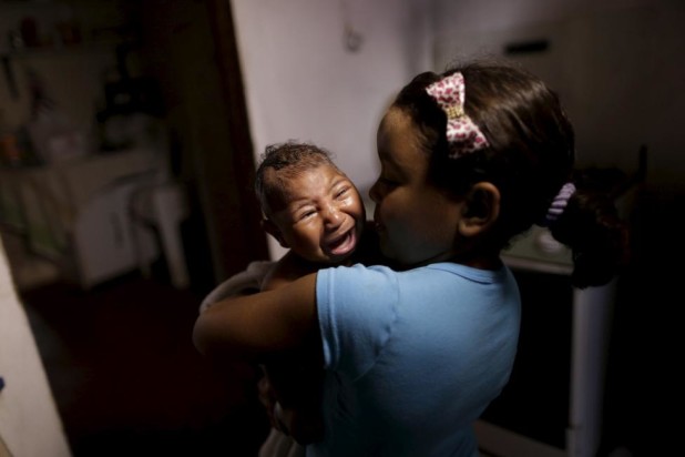 Camile Vitoria embraces her brother Matheus, who has microcephaly, in Recife, Brazil, January 27, 2016.  REUTERS/Ueslei Marcelino