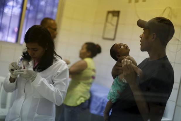 A nurse of the Oswaldo Cruz Hospital prepares to draw blood from baby who has microcephaly, in Recife, Brazil, January 26, 2016. REUTERS/Ueslei Marcelino