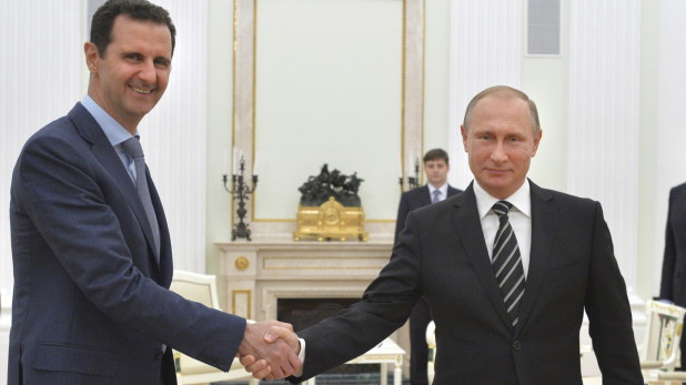 Russian President Vladimir Putin shakes hands with Syrian President Bashar Assad during Tuesday's meeting at the Kremlin in Moscow.