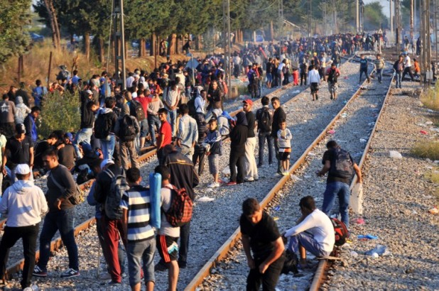 Migrants and refugees wait to cross the Greece-F.Y.R. Macedonia border near the village of Idomeni, in northern Greece on September 13, 2015. Three people, including a child, drowned when a boat carrying some 100 migrants capsized off Greece early on September 13, the Athens News Agency reported. It said the coastguard had rescued 68 people following the incident off the island of Farmakonisi in the Southern Aegean Sea. AFP PHOTO /STR