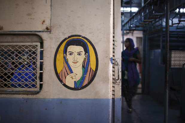 A portrait of a woman is seen near the entrance of the female compartment of a suburban train at Chhatrapati Shivaji Terminus Railway Station in Mumbai November 2, 2012. In India some train compartments, or sometimes whole trains, are reserved specifically for female passengers in an effort to make their travel easier and more secure. The role and treatment of women in society has recently become a hot political issue in the country, since the Dec. 16 gang rape of a 23-year-old student in New Delhi, who later died of her injuries, and whose case has led to widespread protests in the region against violence against women. Picture taken November 2, 2012.          REUTERS/Navesh Chitrakar (INDIA - Tags: SOCIETY CIVIL UNREST TRANSPORT) ATTENTION EDITORS - PICTURE 10 OF 11 FOR PACKAGE 'LADIES ONLY ON INDIA'S TRAINS' SEARCH 'FEMALE TRAINS' FOR ALL IMAGES - RTR3C8GF