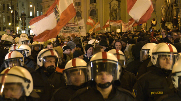 Demonstrators wave flags and show banners during a rally of the group Patriotic Europeans against the Islamization of the West, or PEGIDA, in Vienna, Austria, Monday, Feb. 2, 2015. (AP Photo/Hans Punz)