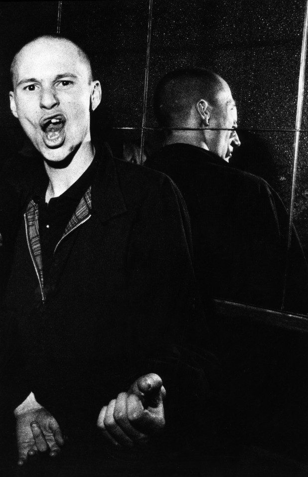 A Skinhead, gesturing to camera, Electric Ballroom, London, UK, 1980's