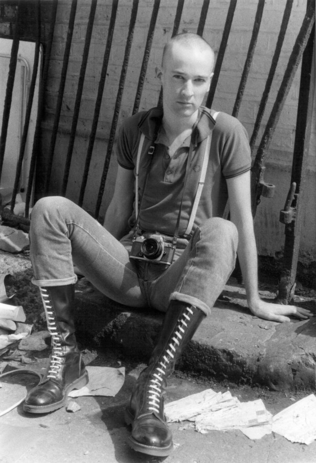 Paul Hartnett portrait. Dressed as a skinhead with Doc Martin boots and Fred Perry shirt, UK 1980's