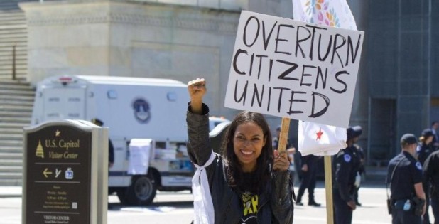 Actress Rosario Dawson takes part in a demonstration on Capitol Hill in Washington, Friday, April 15, 2016. The demonstration, called Democracy Spring, is advocating a set of reforms the organizers have dubbed the "democracy movement," demanding Congress amend campaign finance laws and restore the Voting Rights Act, among other actions. (AP Photo/Pablo Martinez Monsivais)