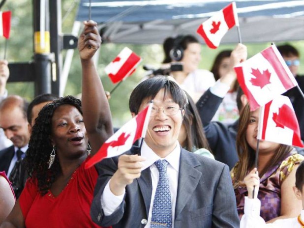 toronto-on-july-1-2010-a-group-of-new-canadians-waves