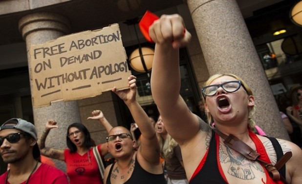 Pro-abortion rights supporters chant at the state Capitol in Austin, Texas, on Tuesday July 2, 2013. Gov. Rick Perry has called lawmakers back for another special session with abortion on the top of the agenda. (AP Photo/Austin American-Statesman, Jay Janner)