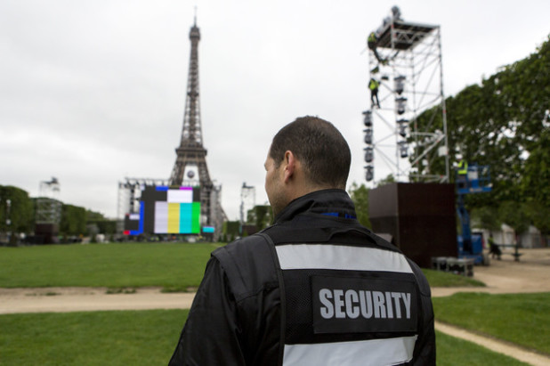 A security guard looks at the Euro 2016 fan zone, under construction on the Champs de Mars in Paris, Friday, June 3, 2016. France's interior minister says the Paris police chief wants more security staff to protect fans at the 2016 European Championship, which starts next week. (AP Photo/Kamil Zihnioglu)